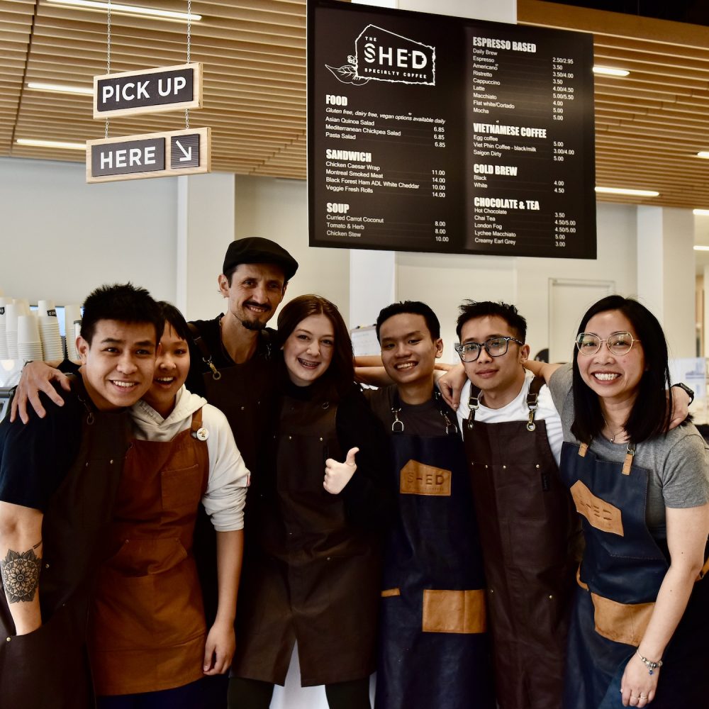 Barista team members of The Shed Coffee gather for a photo in the specialty coffee shop's library location in downtown Charlottetown.